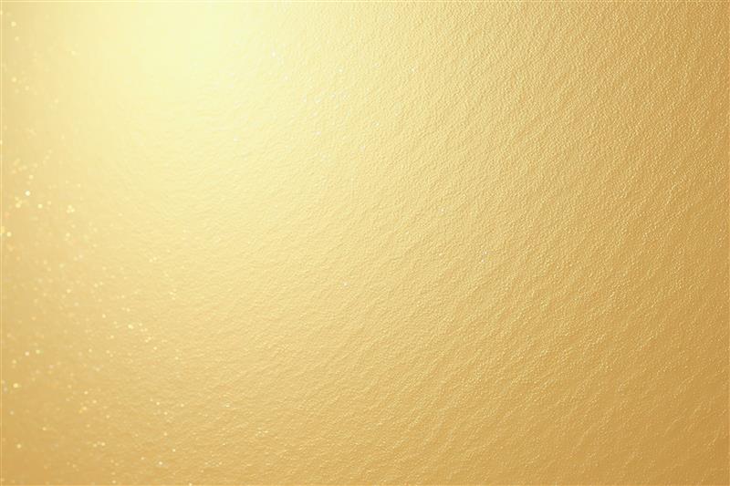 A close-up of a textured golden surface with a slight shimmer, reminiscent of luxury bathroom designs, creates an elegant and warm appearance.